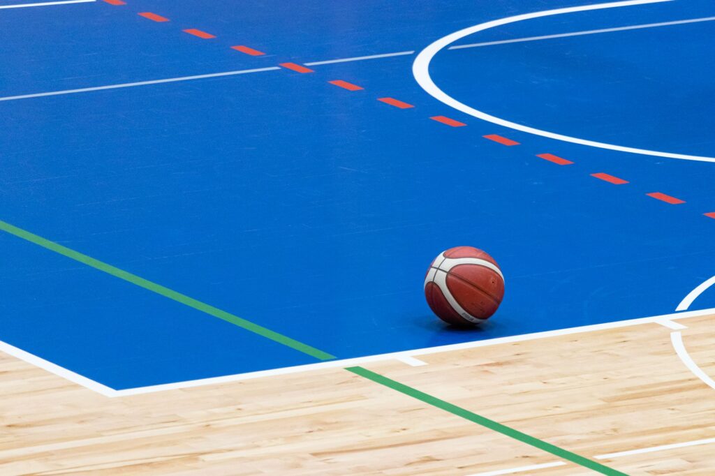 Basketball court with hoop in an empty indoor arena