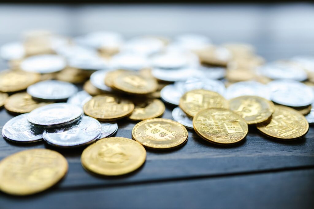 Close-up of digital cryptocurrency coins next to a smartphone