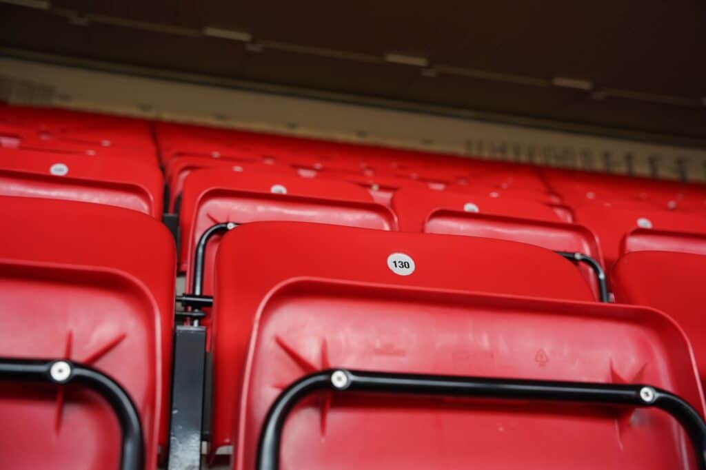 Empty stadium seating overlooking a soccer pitch