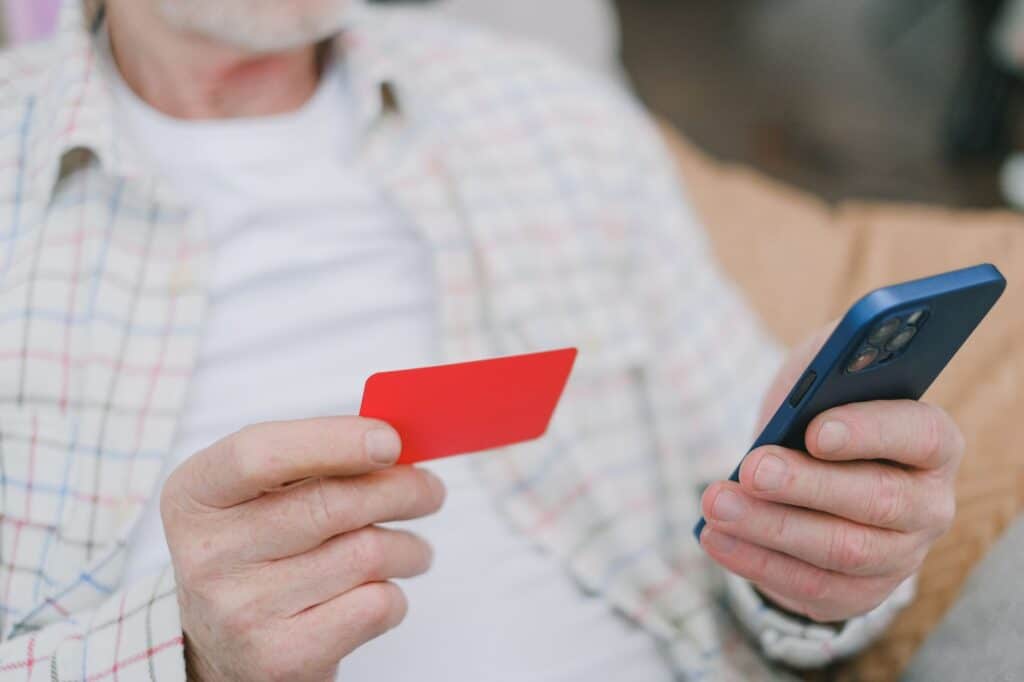 Person using a smartphone to complete an online payment transaction