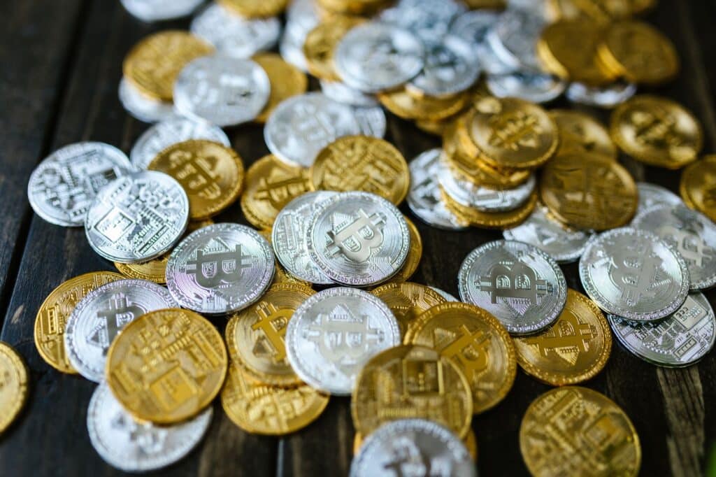 Close-up of digital cryptocurrency coins beside a laptop keyboard