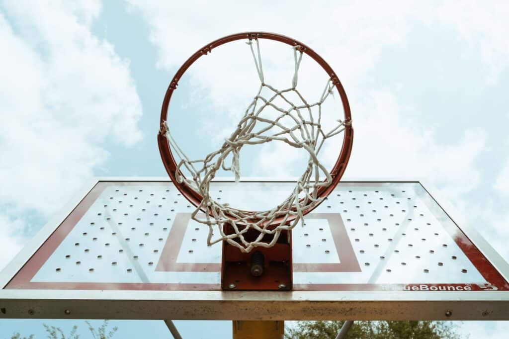 Empty basketball court with a hoop under natural light