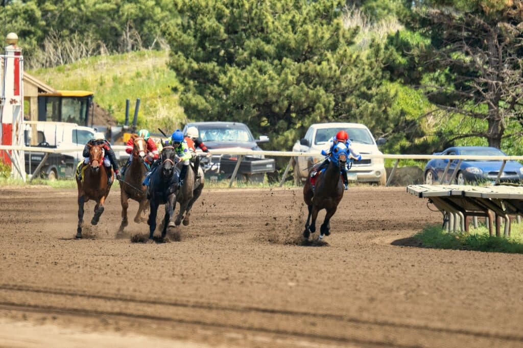 Horses racing on a track during a race event