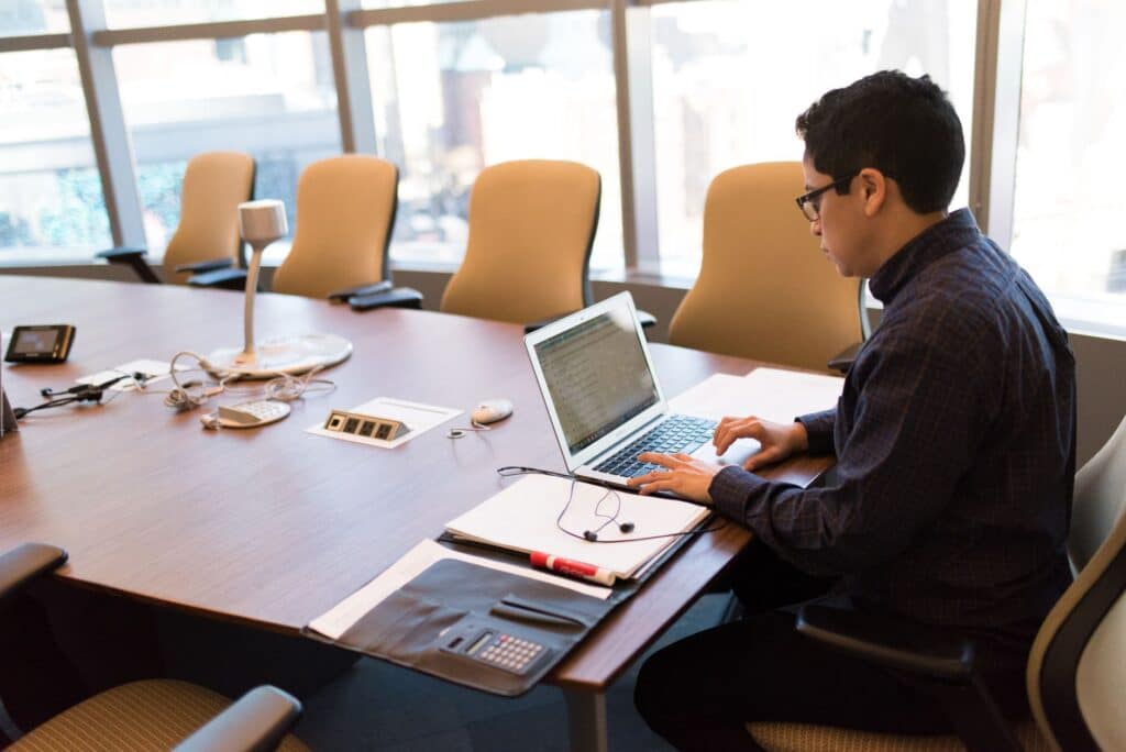 Person sitting at a desk using a laptop computer