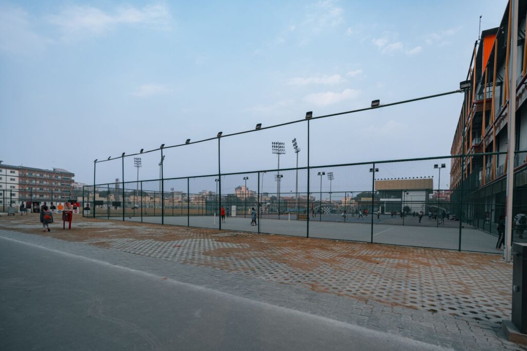 Football stadium under bright floodlights at night