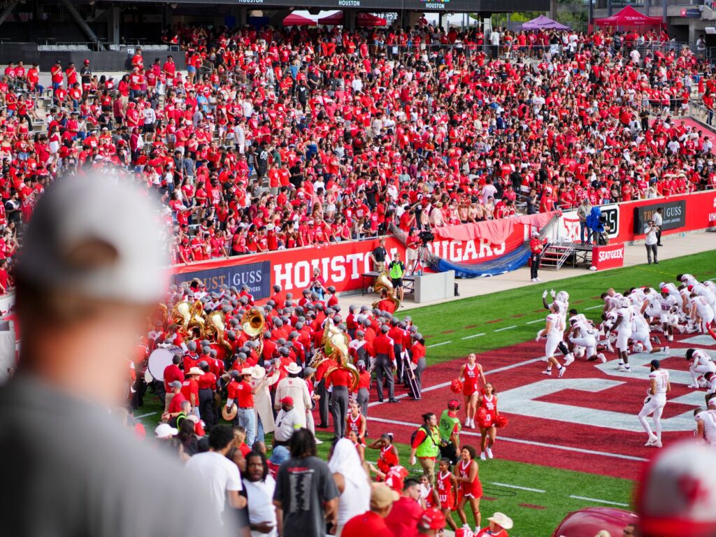 Wide view of a football stadium filled with spectators during a game