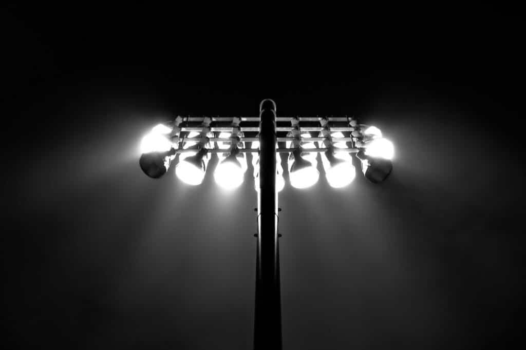 Football stadium under floodlights during an evening match
