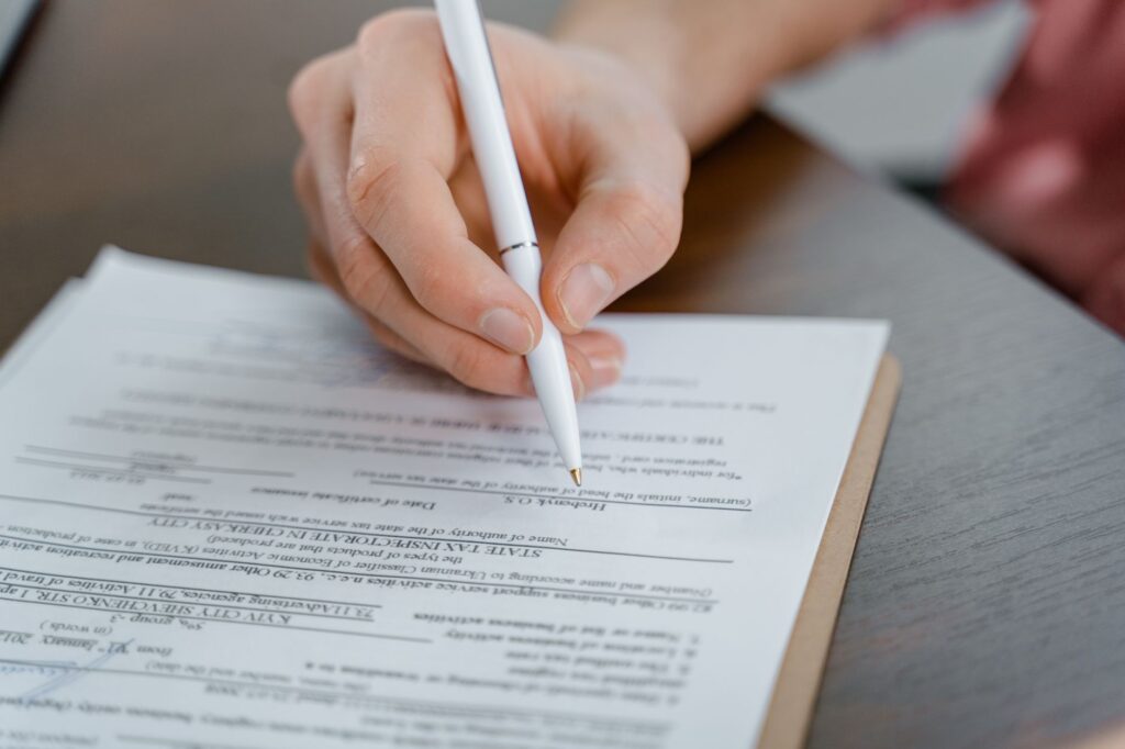 Person holding a smartphone while filling in an online registration form