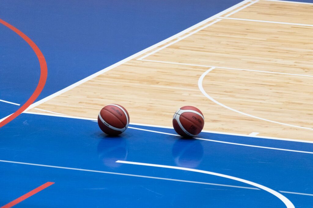 Basketball players in action on an indoor court during a game