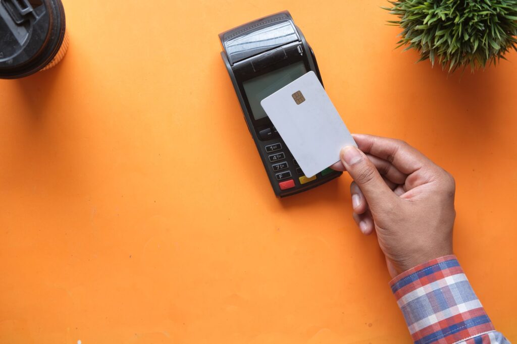 Close-up of a card being tapped on a contactless payment terminal
