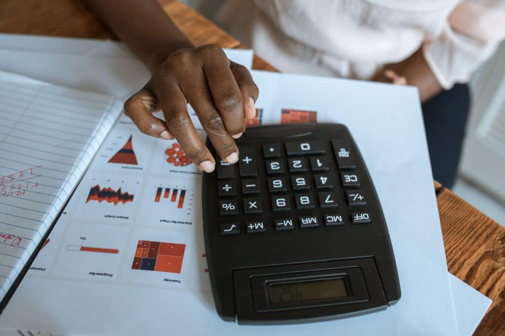 Notebook and calculator on a desk used for reviewing figures
