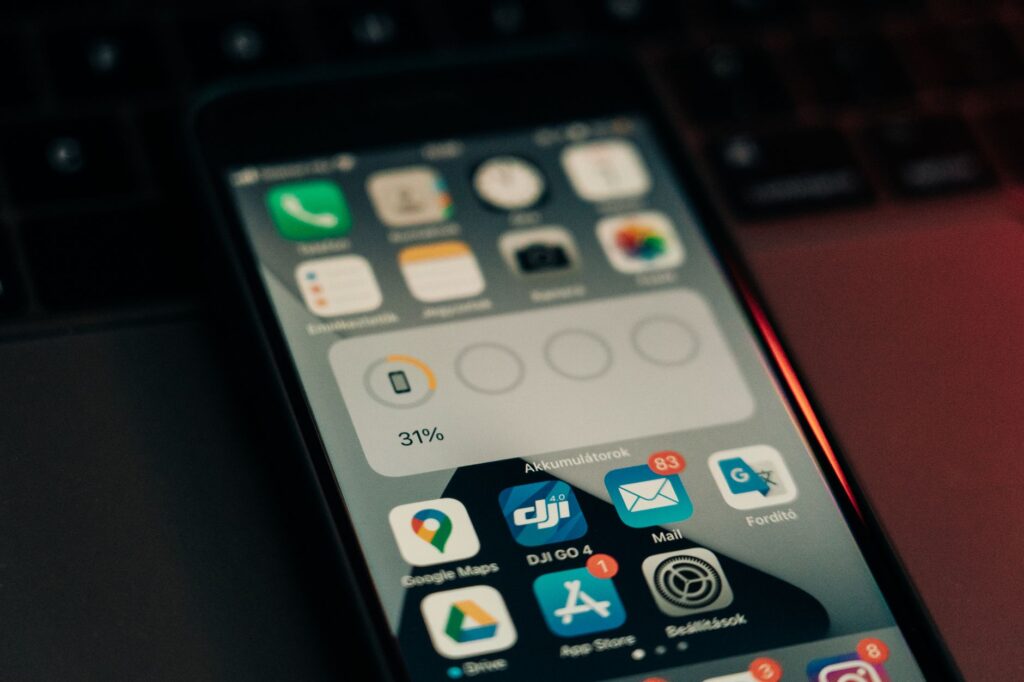 Person holding a smartphone displaying a sports betting app interface