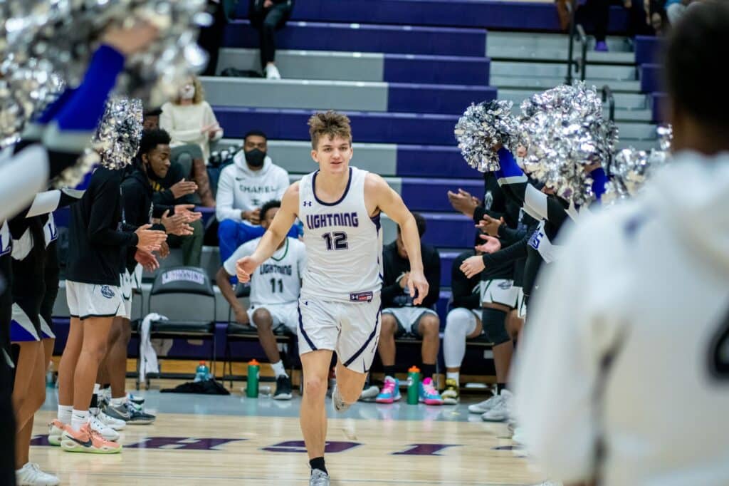 Players competing during a college basketball game on the court