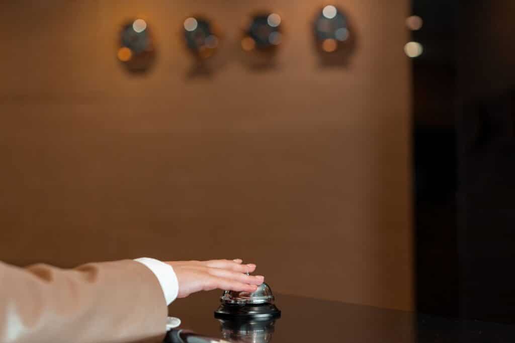 A hotel concierge desk with a staff member assisting a guest