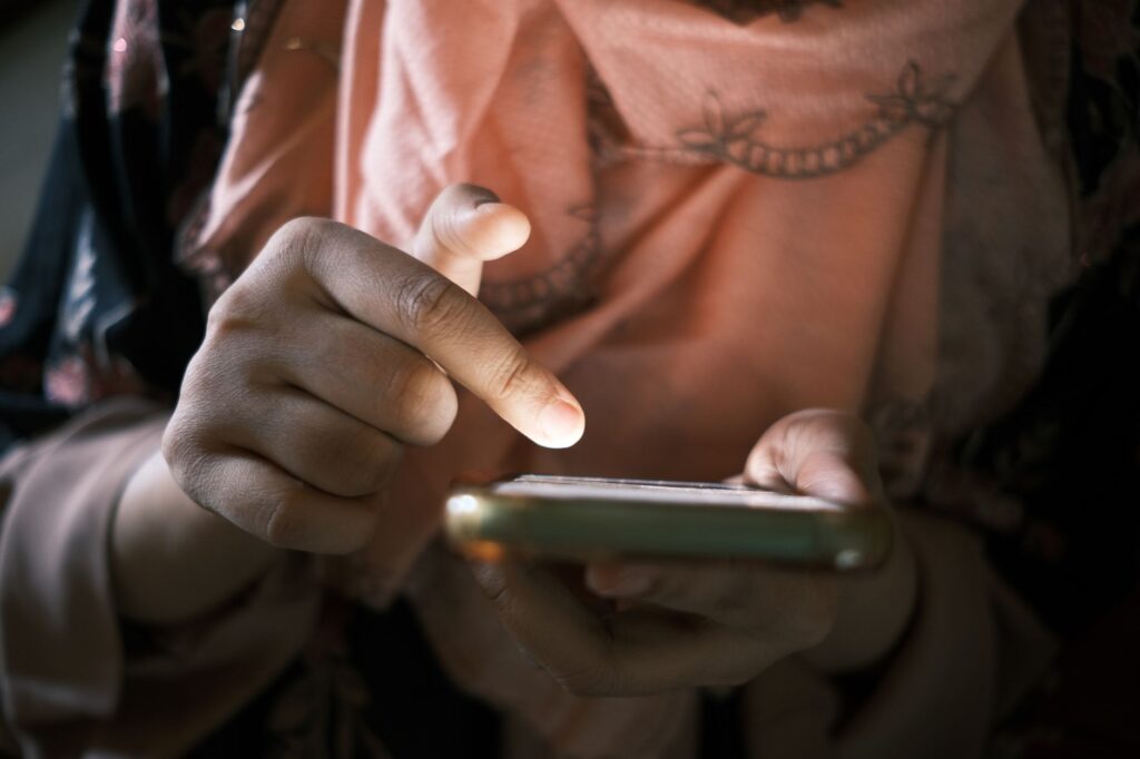A person holding a smartphone while browsing on a mobile browser