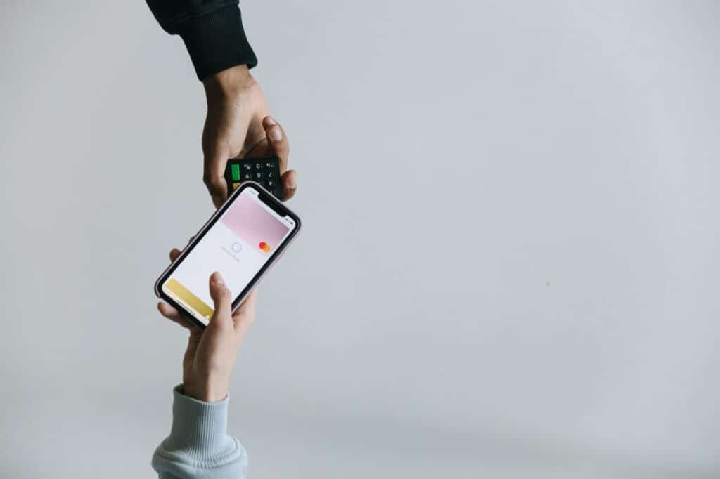 A person holding a smartphone while making an online payment