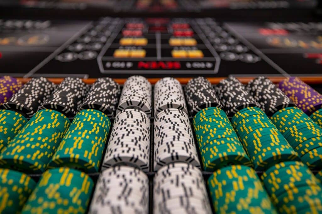 Casino chips arranged on a gaming table under soft lighting