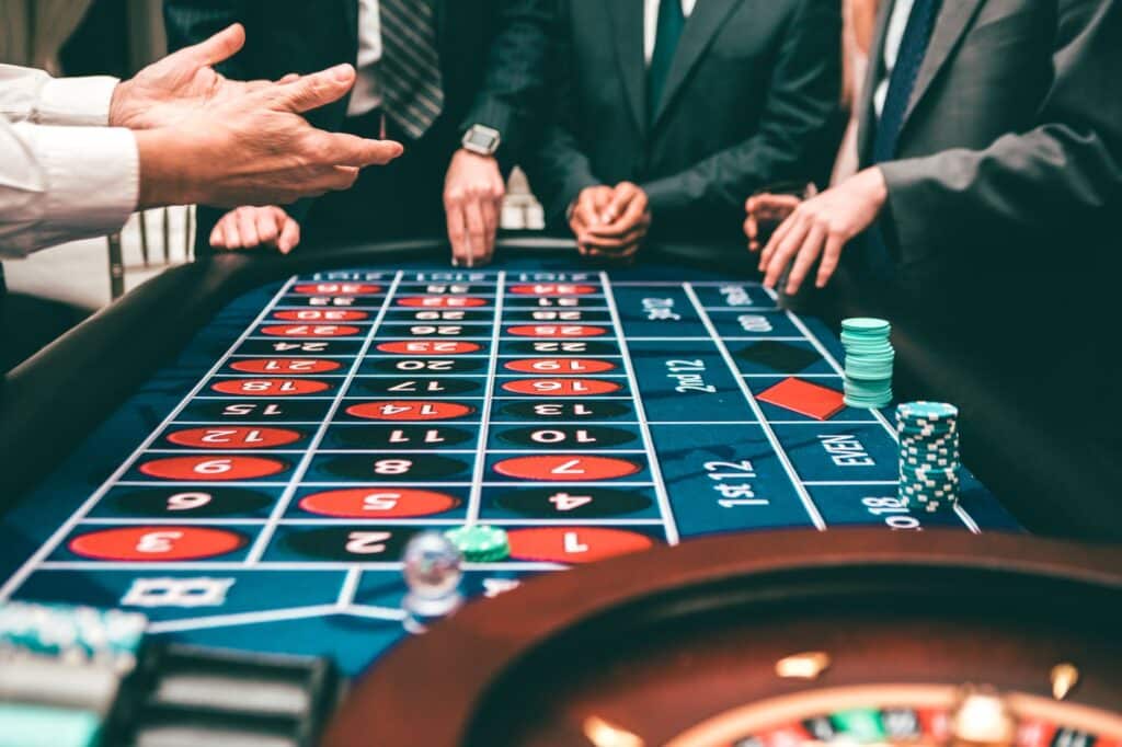 Casino chips arranged on a roulette table under soft lighting