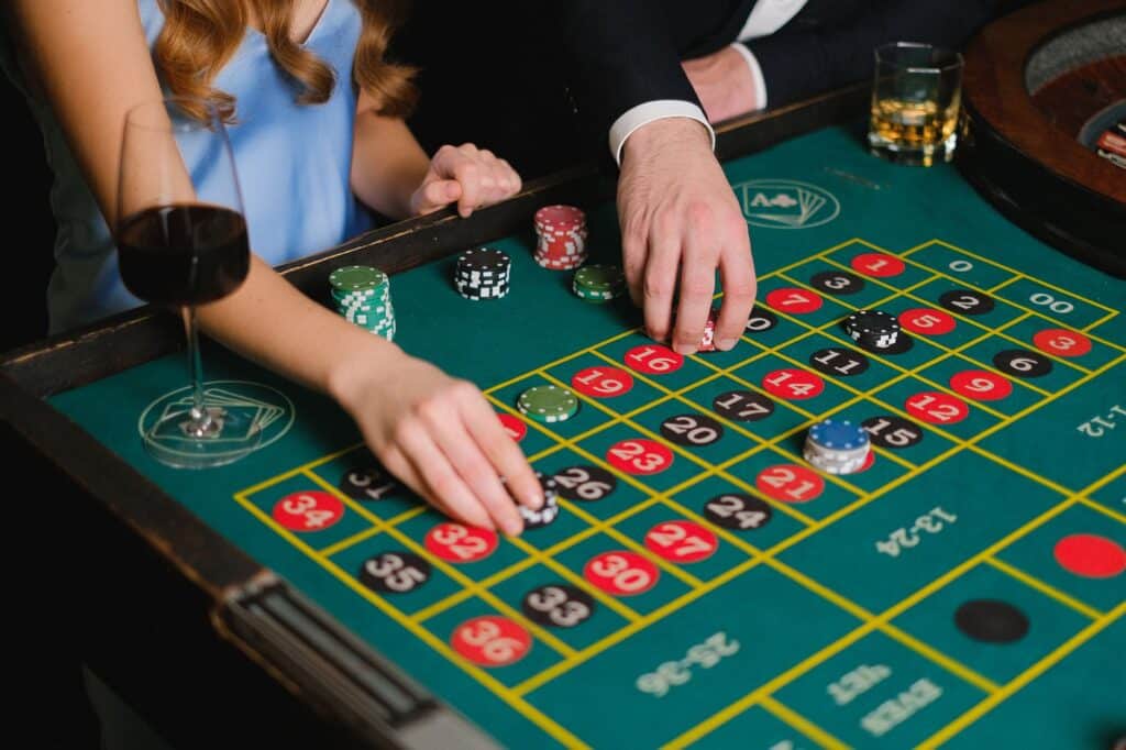 Casino chips arranged on a roulette table under soft lighting