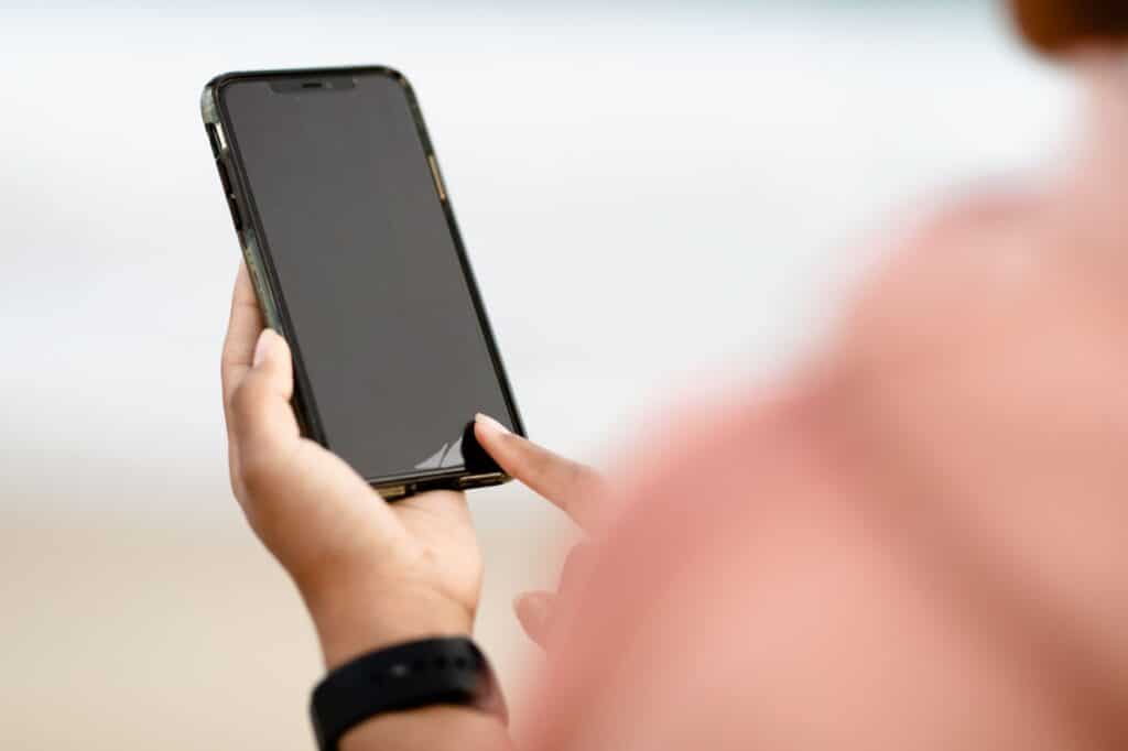 Close-up of a hand holding and using a smartphone