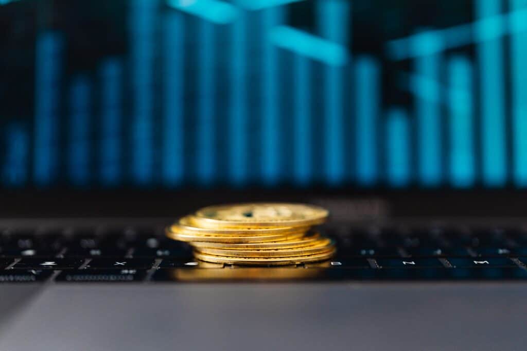 Cryptocurrency coins placed next to a laptop keyboard