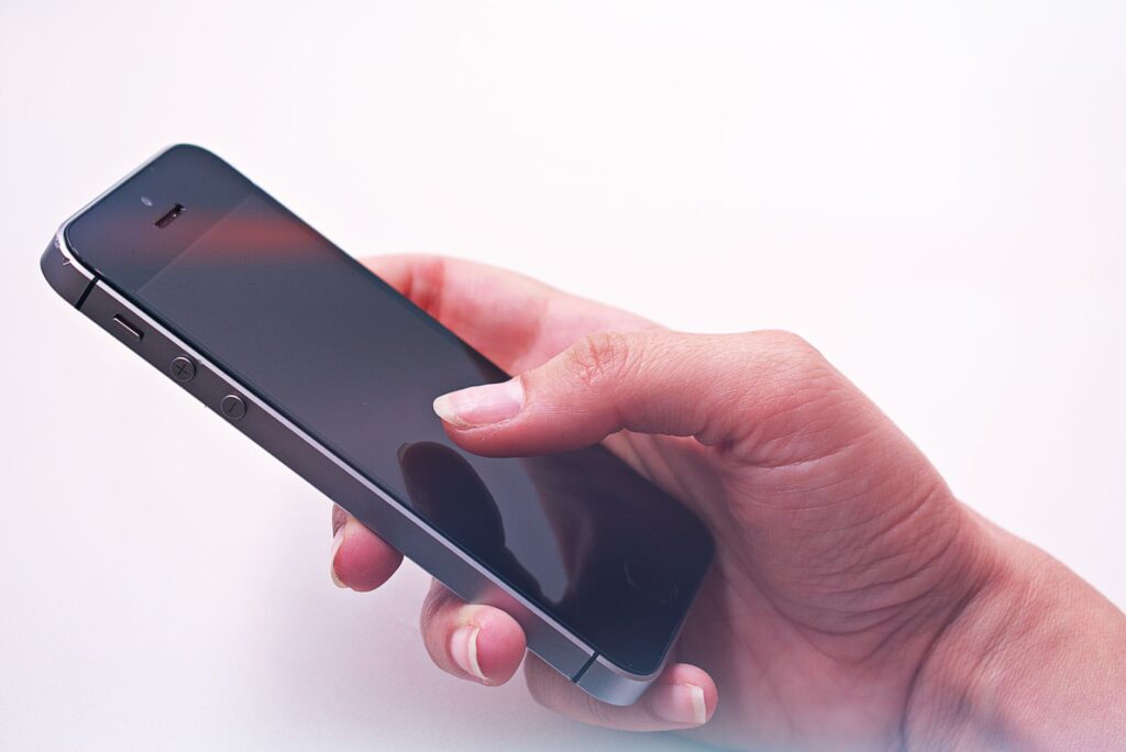 Person holding a smartphone with both hands, using a mobile browser