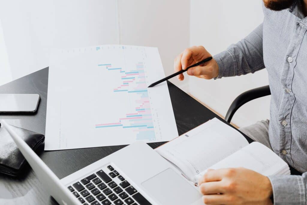 Person reviewing charts and data on a laptop screen