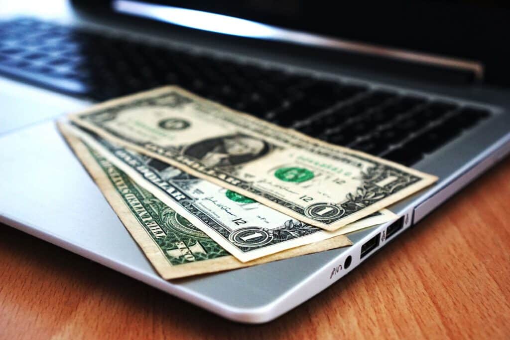 Person using a laptop to process an online payment or withdrawal