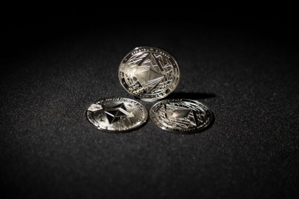 Physical Ethereum coin resting near a laptop keyboard