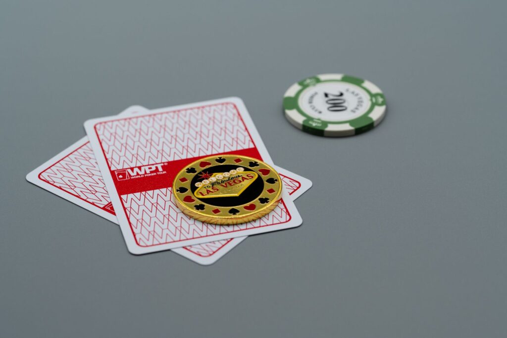 Stacked casino chips arranged near cards on a table surface