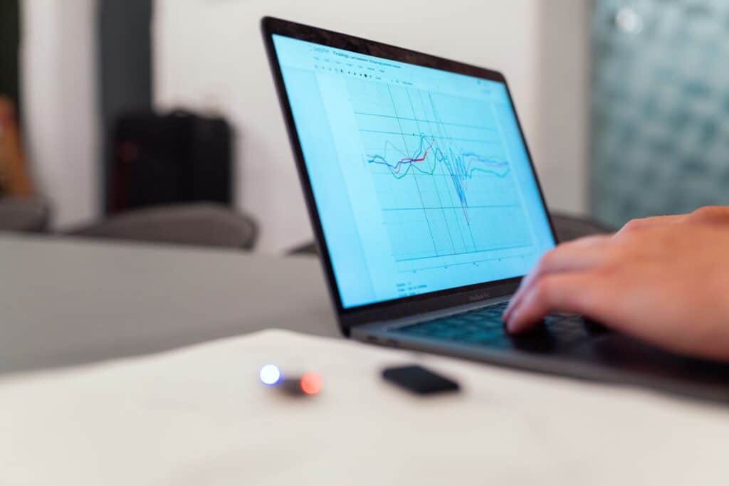 Close-up of a computer screen displaying live data graphs and charts