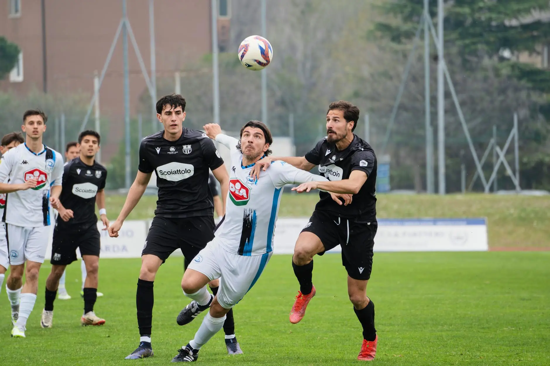 Italian players in a Serie A match, competing for the ball on the field.